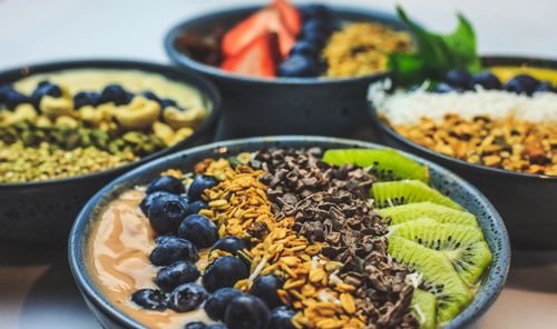 Free Vibrant smoothie bowls adorned with fresh fruits, seeds, and nuts. Perfect for a healthy food concept. Stock Photo