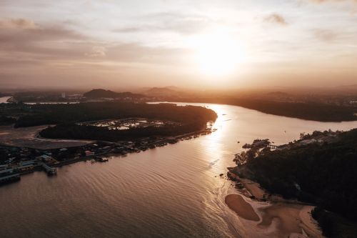 Free Breathtaking aerial view of Chukai River in Terengganu at sunset, showcasing stunning reflections and landscapes. Stock Photo