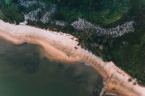 Free Stunning aerial view of a sandy beach and lush greenery in Chukai, Malaysia. Stock Photo