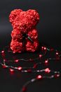 Red Teddy Bear Shaped Valentine's Gift on Black Background