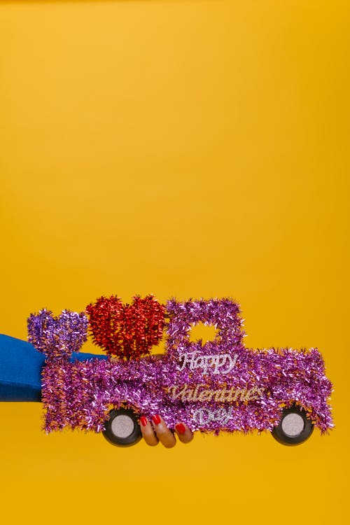 Person Holding Car Shaped Valentine's Gift