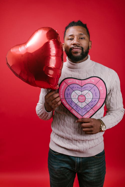 Free Man in White Long Sleeve Shirt Holding Valentine's Day Gifts Stock Photo