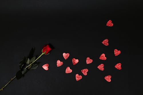 Free Red Rose and Red Heart Shapes on Black Surface Stock Photo