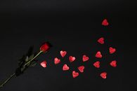 Red Rose and Red Heart Shapes on Black Surface