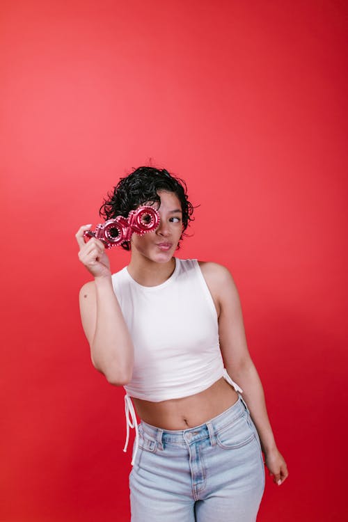 Free Woman in White Tank Top Holding Xoxo Balloon Letters Stock Photo