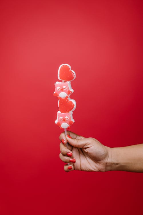 Free Person Holding a Lollipop Stock Photo