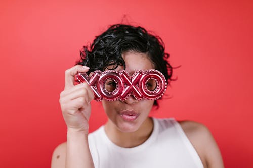 Woman Holding a Xoxo Balloon Letters