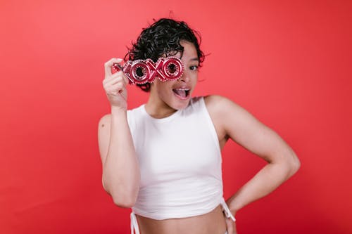 Woman in White Tank Top Holding Xoxo Balloon Letters