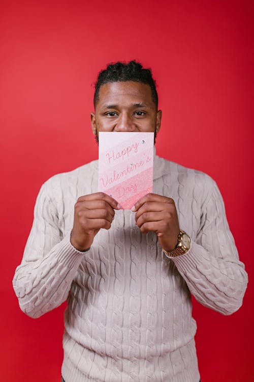 Man in White Long Sleeve Shirt Holding Valentine's Day Card