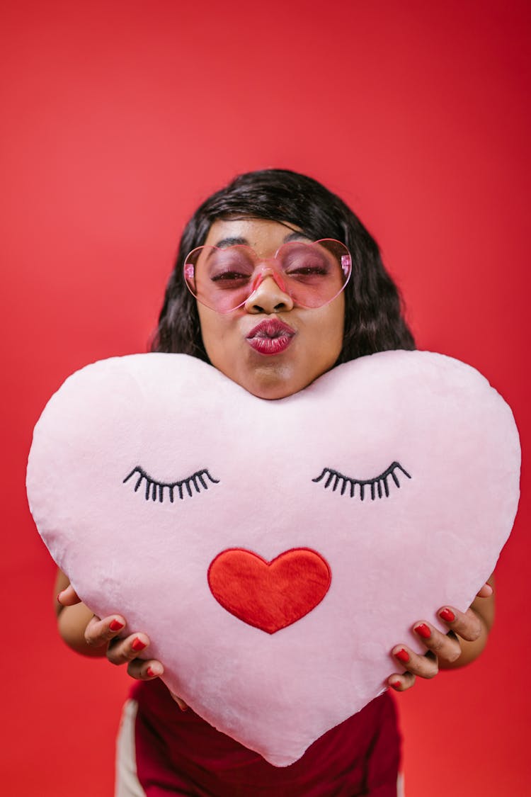 Woman Holding Pink Heart Pillow