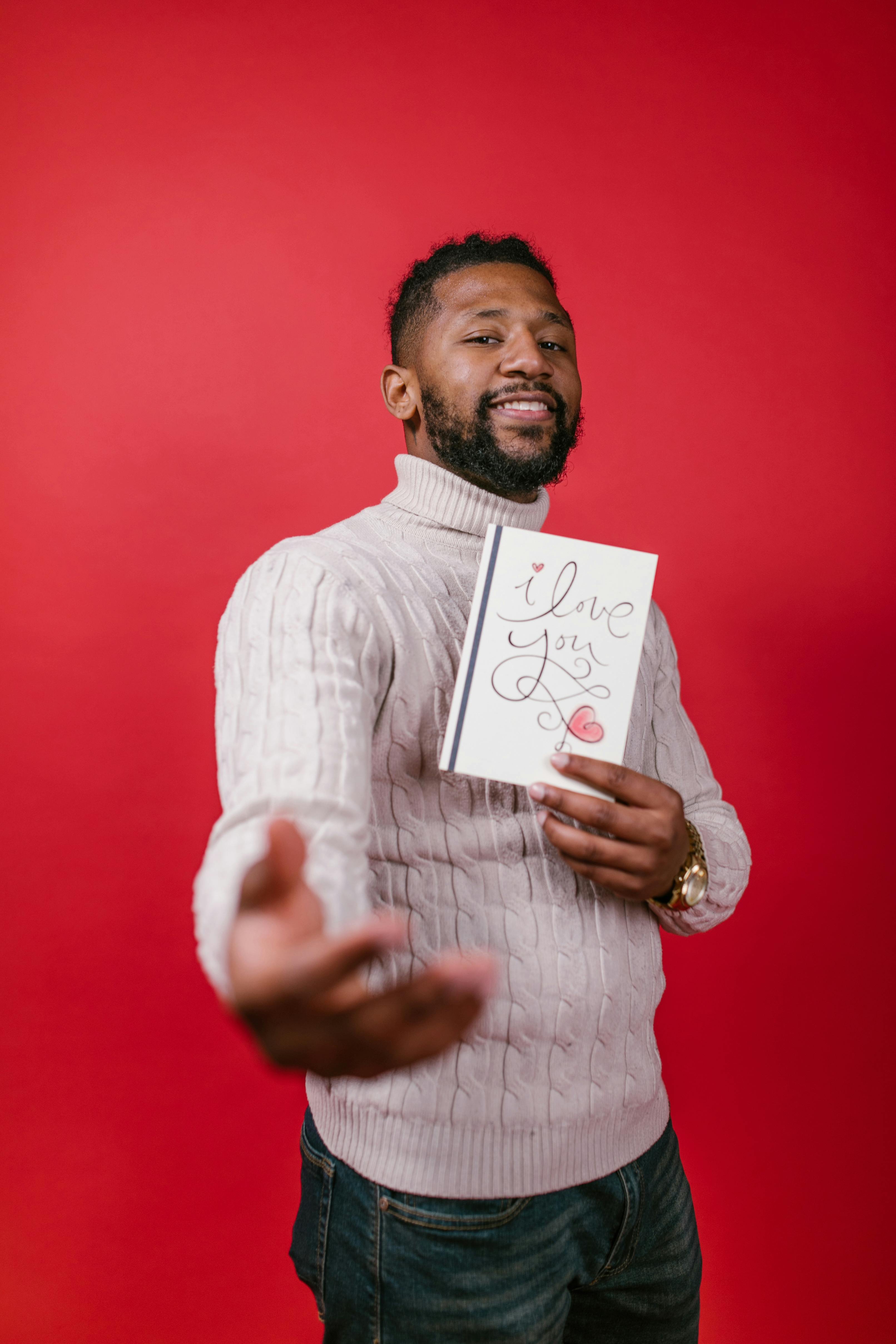 man in white long sleeve shirt holding valentine s day card