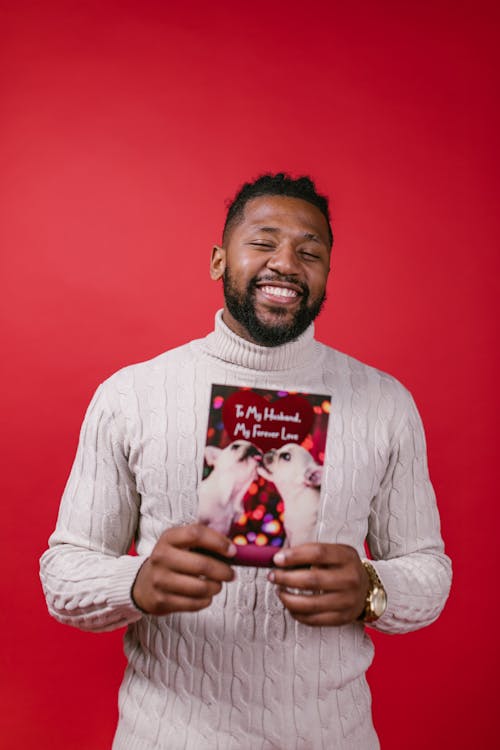 Man in White Long Sleeve Shirt Holding Valentine's Day Card