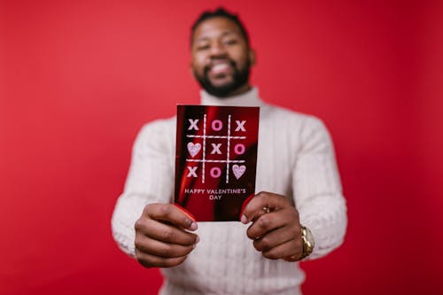 Free Man in White Long Sleeve Shirt Holding Valentine's Day Card Stock Photo