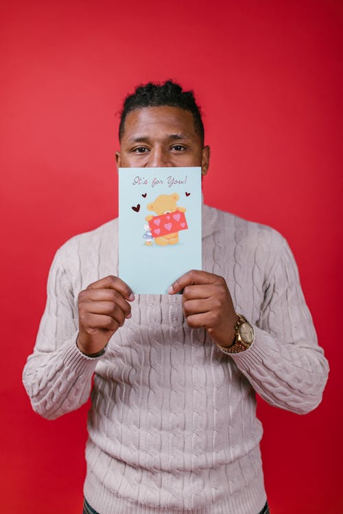 Man in White Long Sleeve Shirt Holding Valentine's Day Card