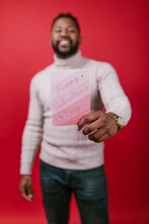 Man in White Long Sleeve Shirt Holding Valentine's Day Card