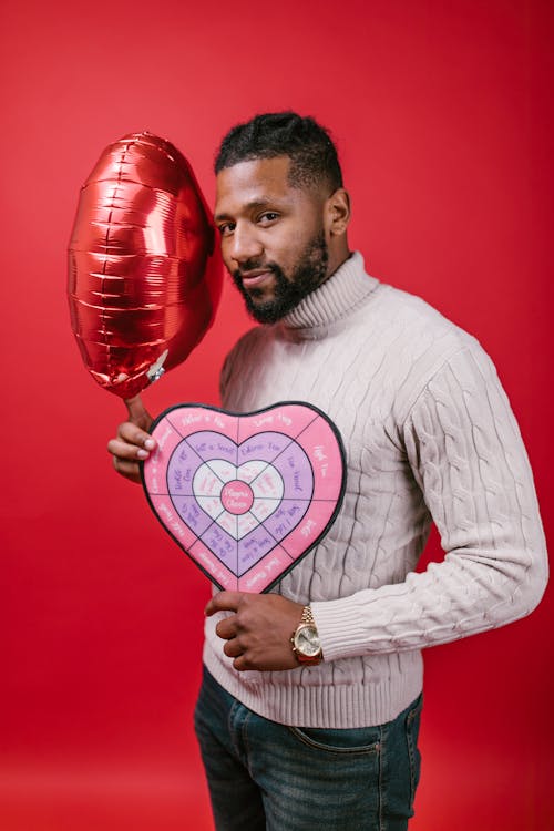 Man in White Long Sleeve Shirt Holding Valentine's Day Gifts