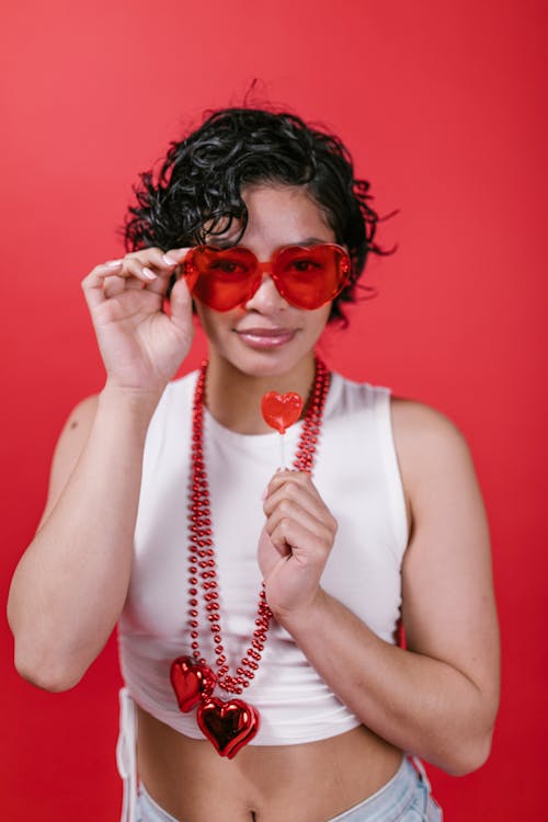 Woman in White Tank Top Wearing Red Sunglasses