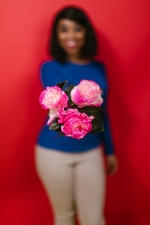 Shallow Focus of a Woman Holding Pink Roses
