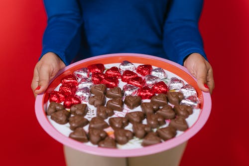 Free Photo Of Person Holding Tray Of Heart Shaped Chocolates Stock Photo