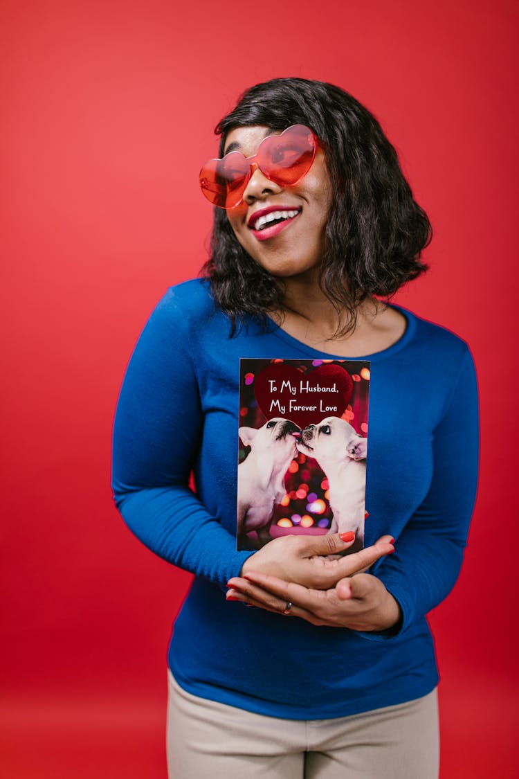 Woman In Blue Long Sleeve Shirt Holding A Valentines Card