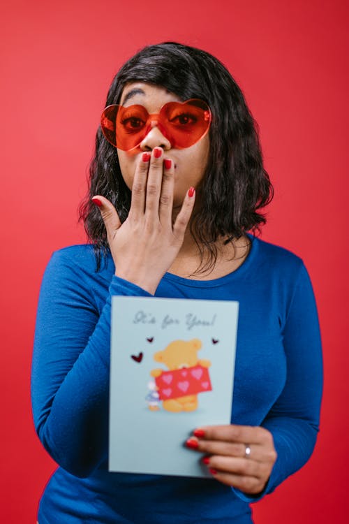 Woman in Blue Long Sleeves Holding a Valentines Card