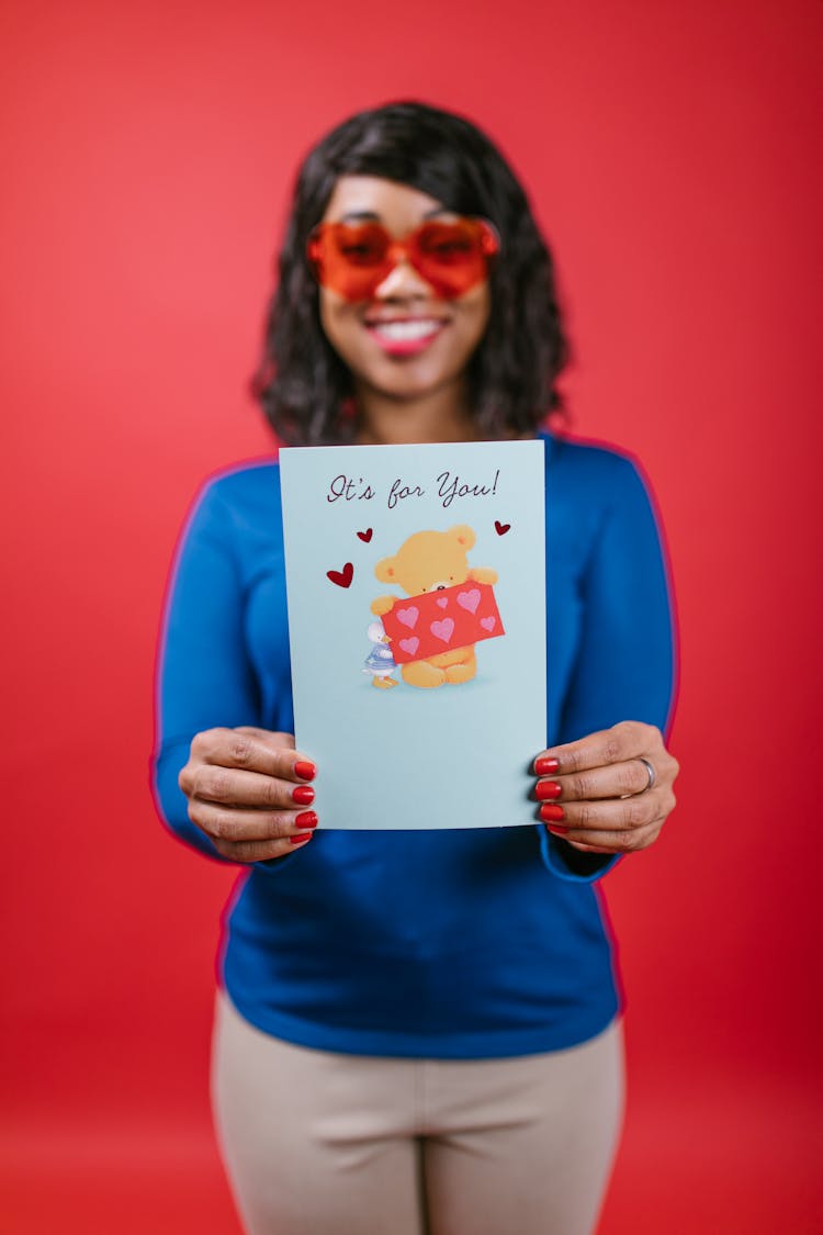 Woman In Blue Long Sleeve Shirt Holding A Valentines Card