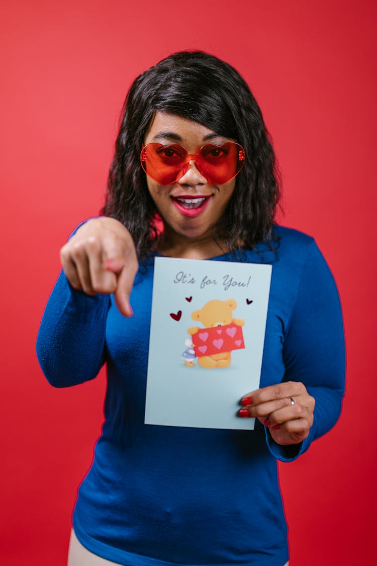 Woman In Blue Long Sleeve Shirt Holding A Valentines Card