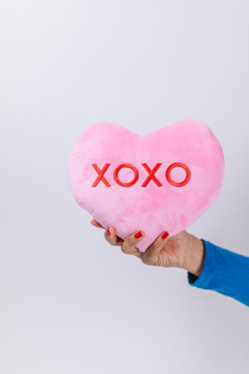 Free Person Holding Pink Heart Pillow Stock Photo