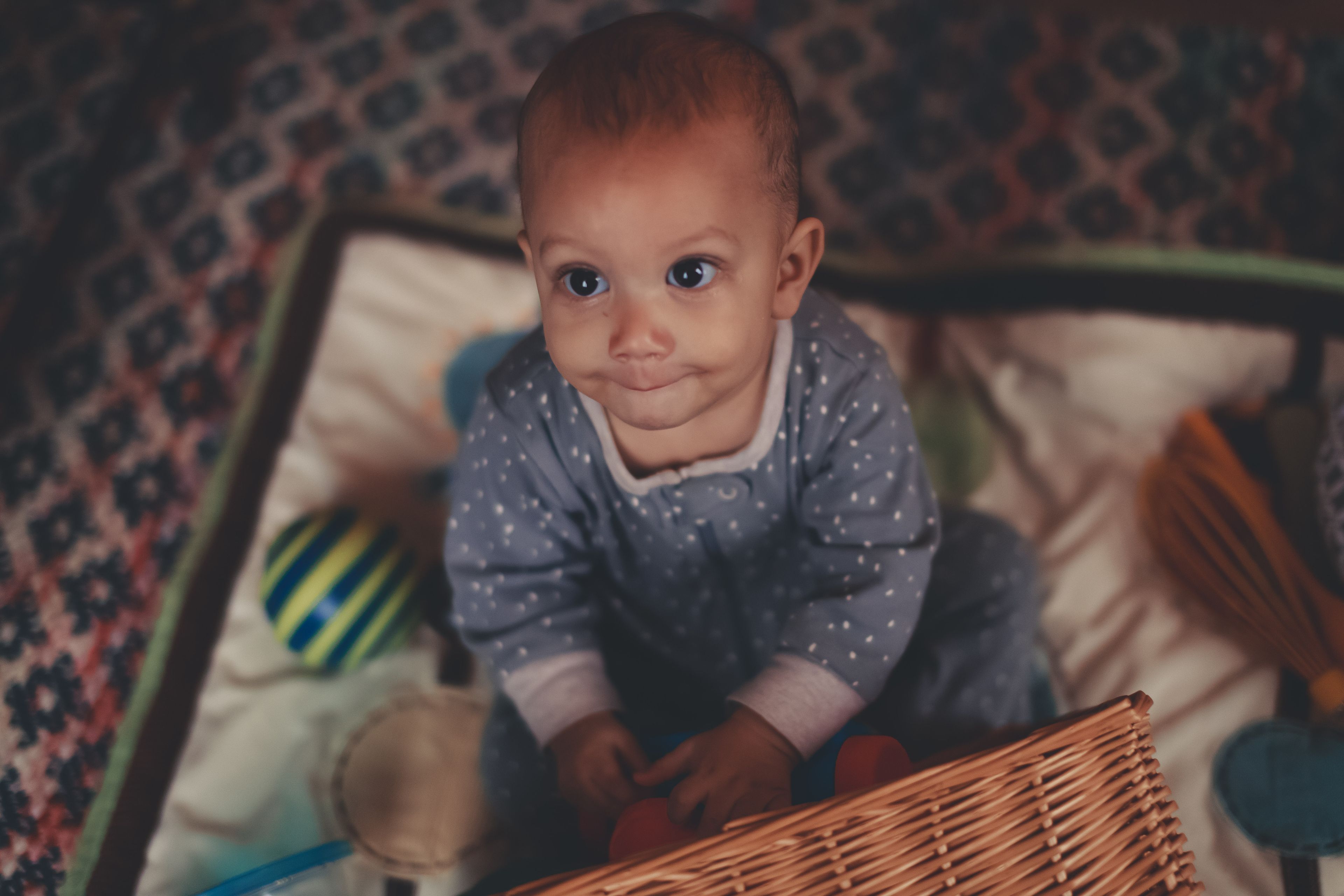 A baby playing with colorful toys