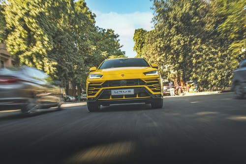 A Yellow Lamborghini Urus on the Road
