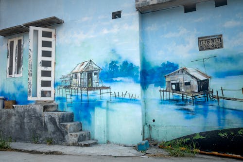 Blue graffiti on wall of shabby building