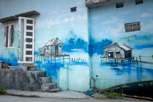 Free Exterior of house with aged stairs and shabby door and window and blue graffiti of houses water on wall Stock Photo