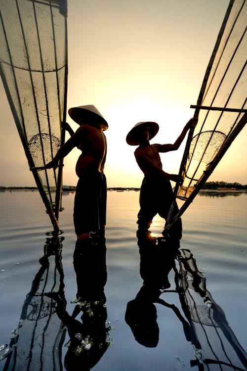 Silhouettes of Fishermen at Dawn