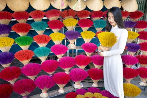 Asian woman with aromatic sticks in shop