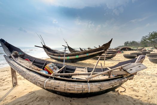 Fishing equipment in old boats on sea shore