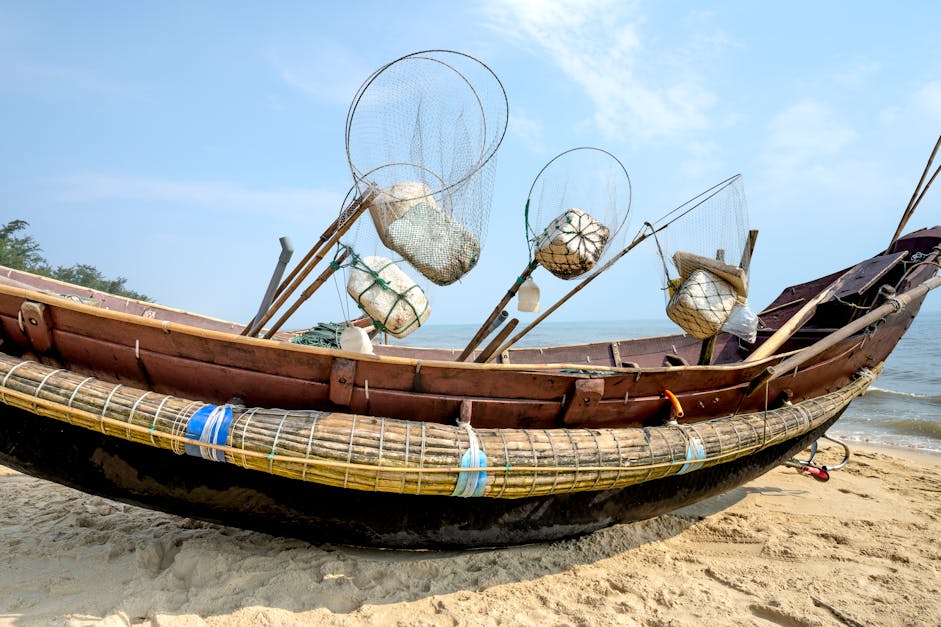 Fishing boat with nets on sea shore · Free Stock Photo