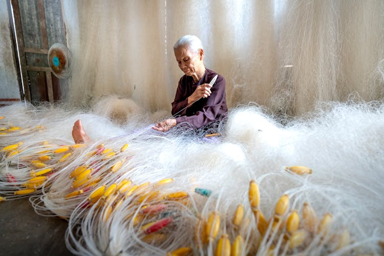 Senior Asian Woman Making Fishing Net At Home