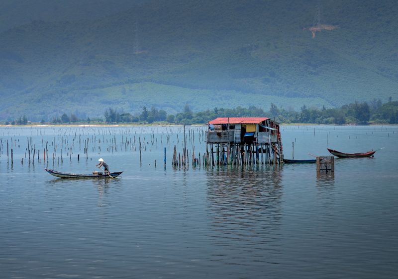 An angler landing a fish from a river boat