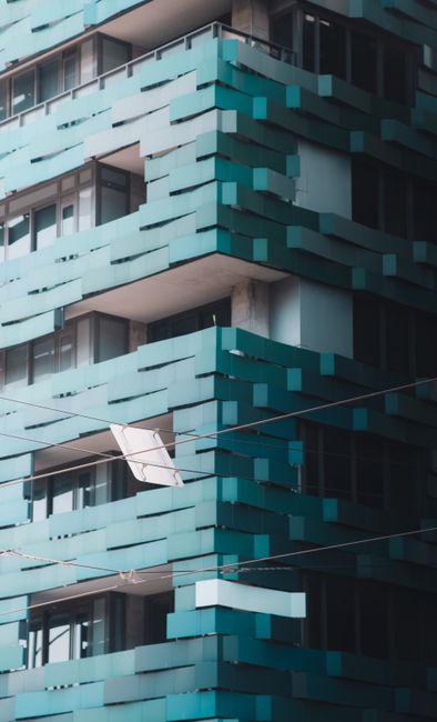 Close-up of a modern architectural building with teal facades in Melbourne, Australia.