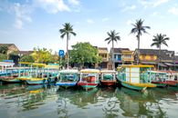 Cruise boats moored on river in tropical village