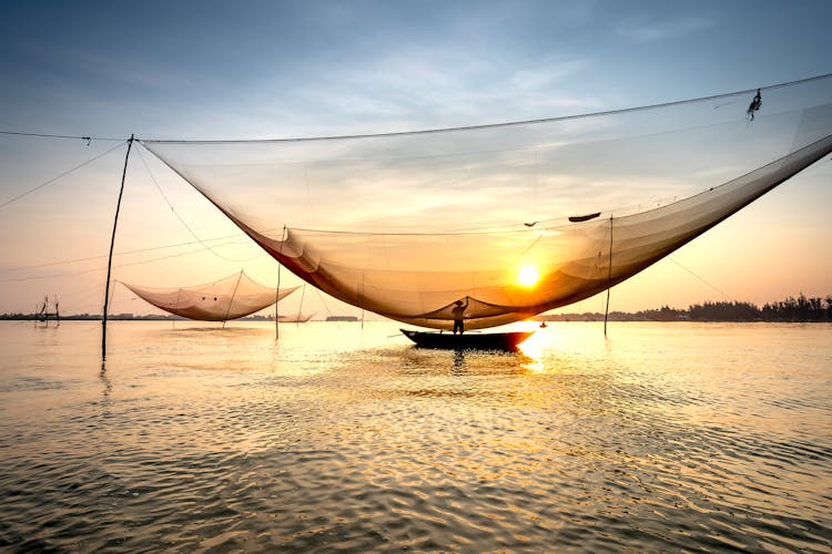 Anonymous Fisherman Casting Fishing Nets