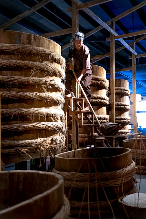 Man working in factory with big barrels