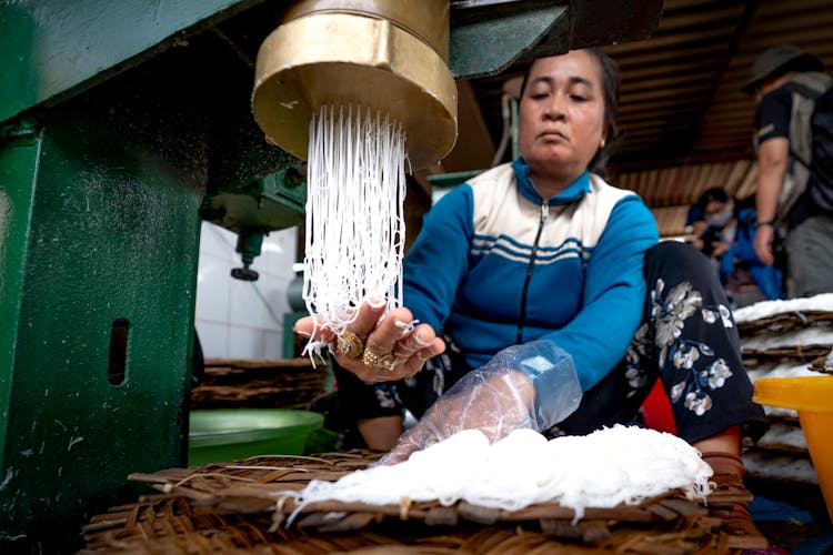 Asian Woman Making Noodle In Manufacture