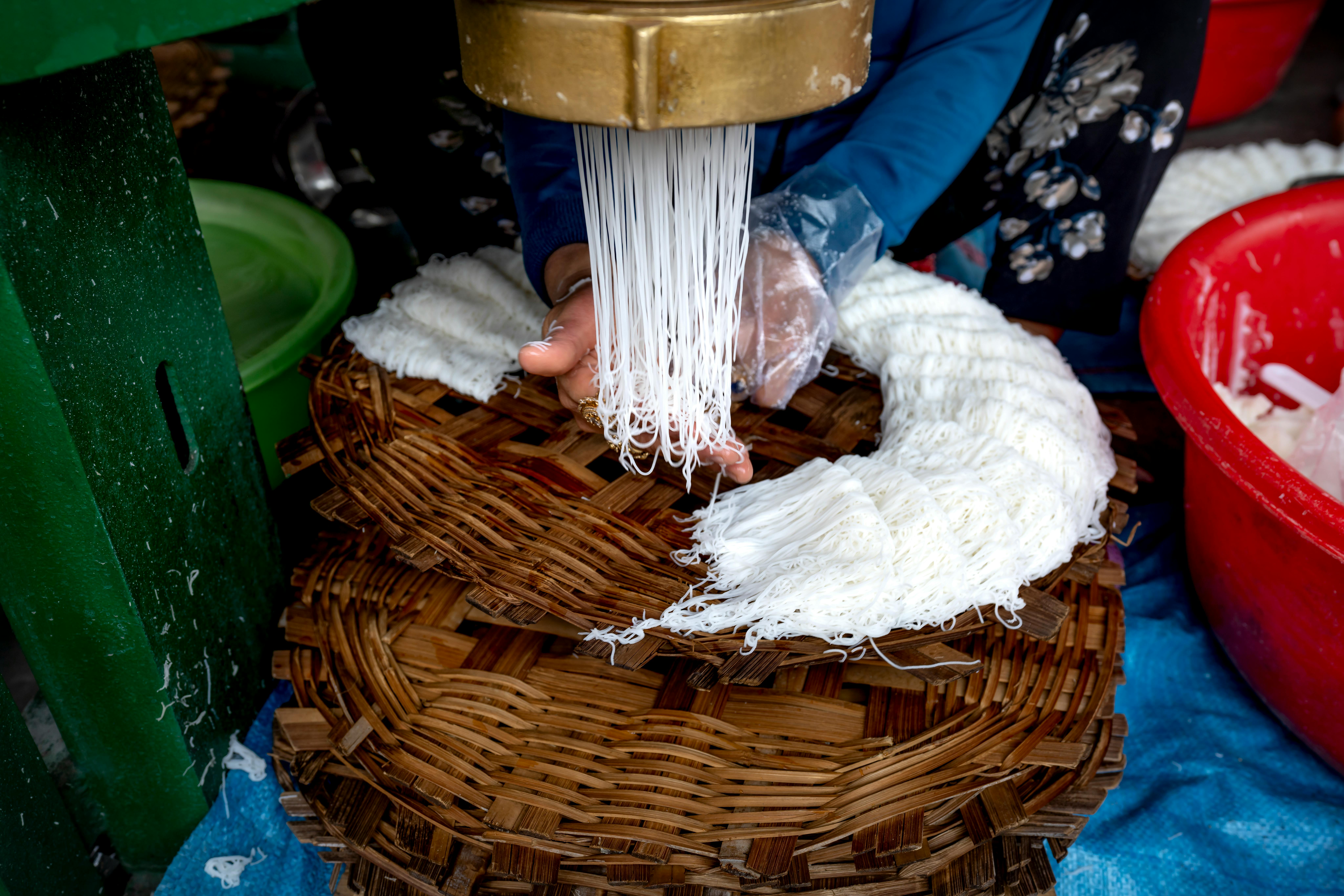 a person making noodles