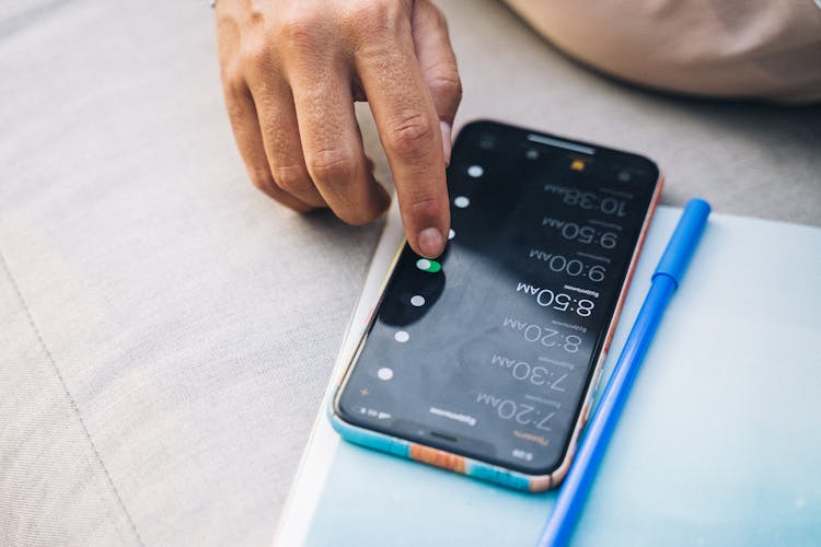 Close-Up Shot Of A Person Touching A Cellphone