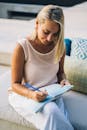A Woman Writing on a Notebook