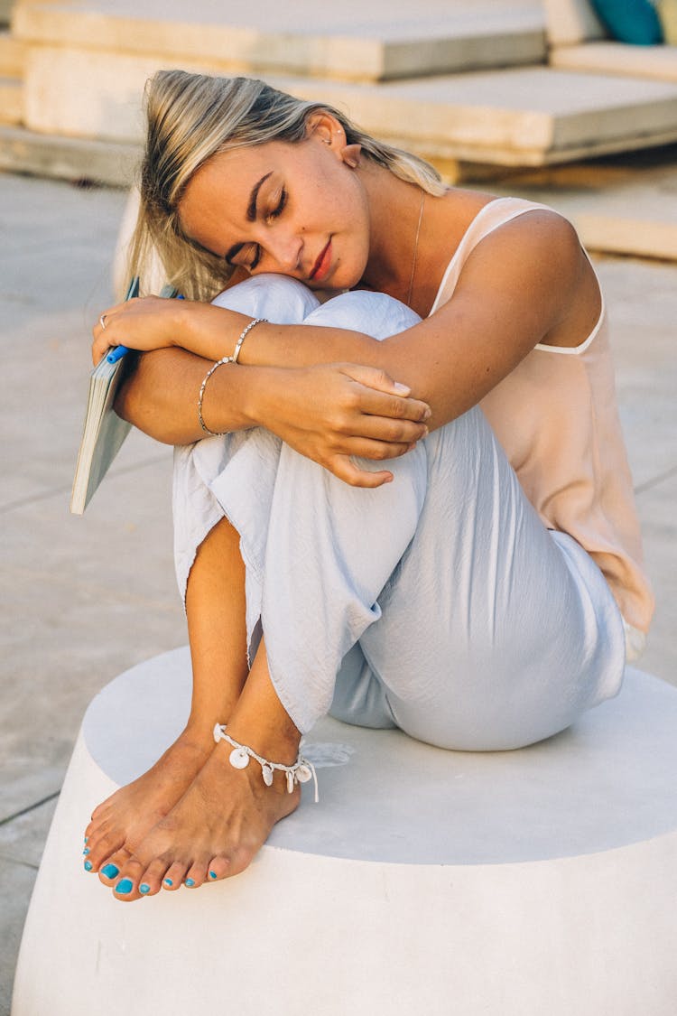 A Woman Hugging Her Knees