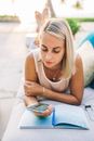 A Blonde Woman Looking at her Cellphone