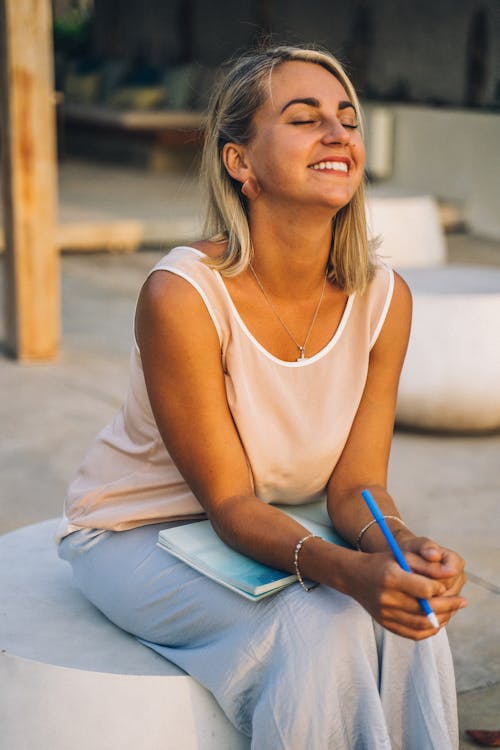 Free A Smiling Woman Sitting Stock Photo