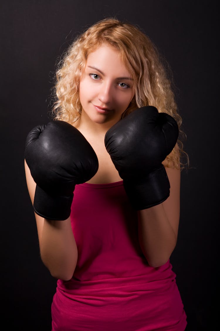 Blonde Woman Wearing A Black Boxing Gloves